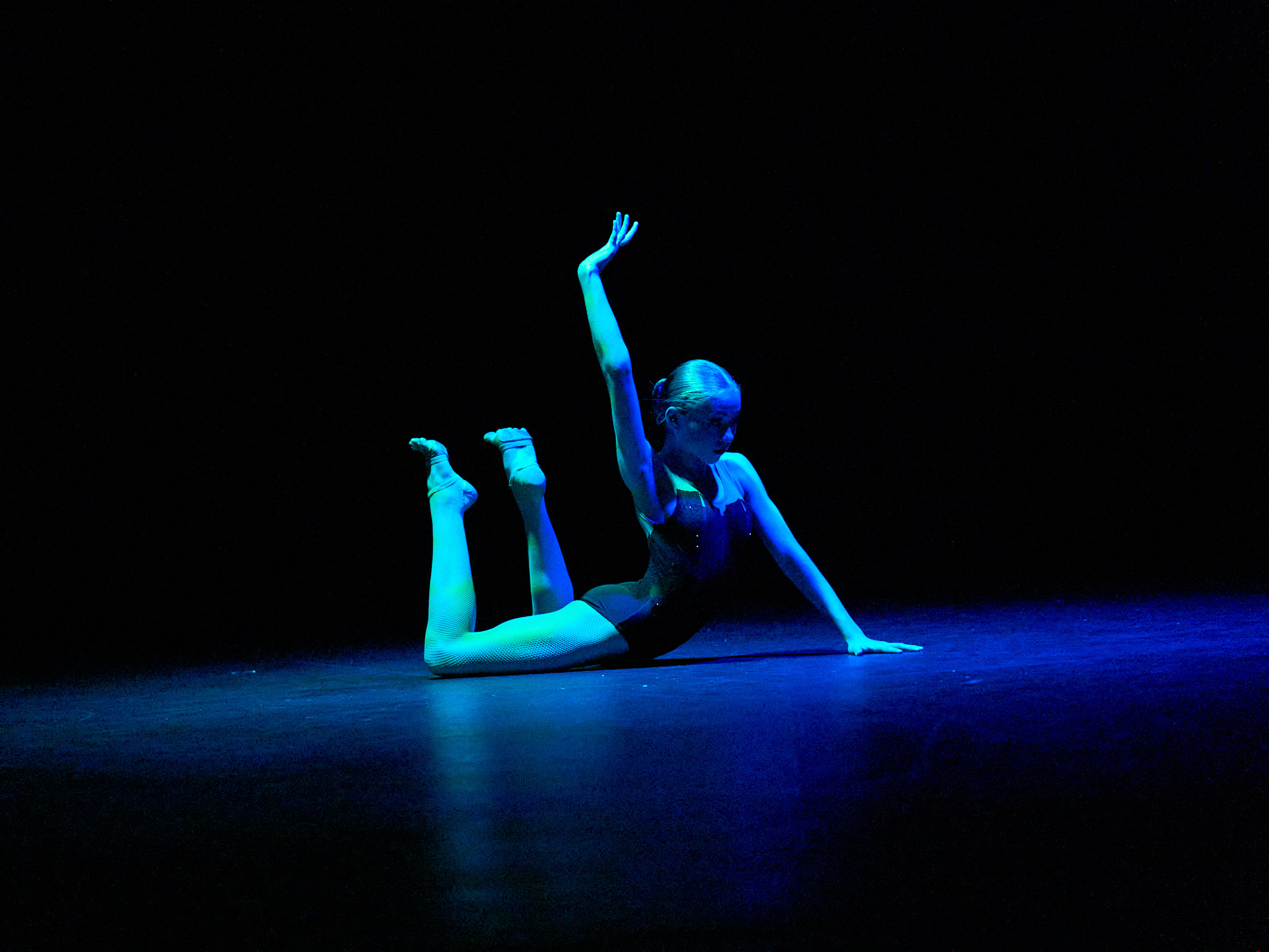 Outline Dance Centre - solo floor pose blue light
