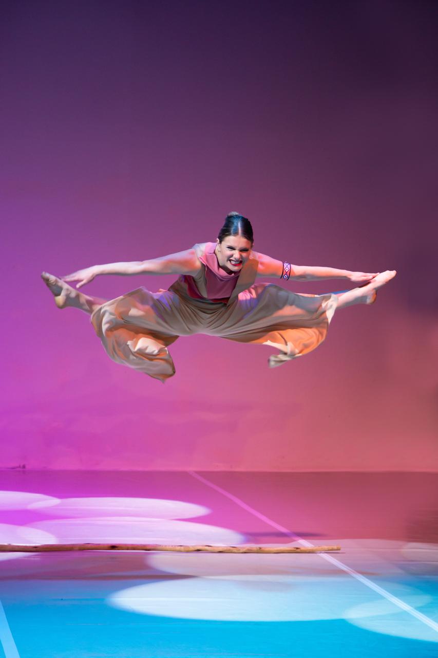 Outline Dance Centre - solo straddle jump pink bg